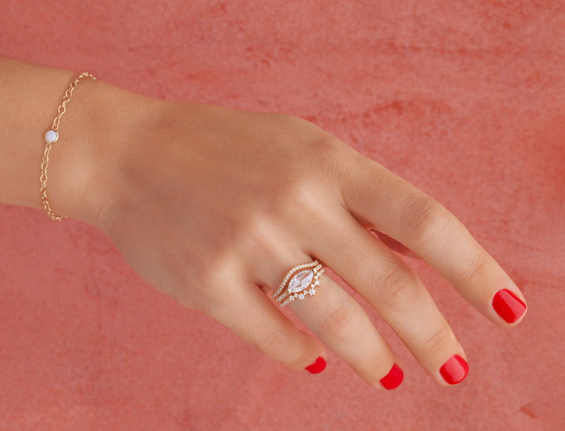 woman's hand - opal with gold chain on woman's wrist
