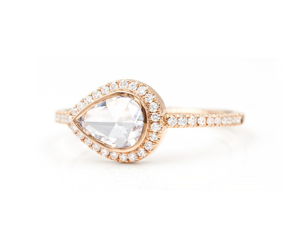 0.60 Carat  east west rose cut pear diamond  in 14k rose gold blair setting with halo and pavé diamonds 3/4 view
