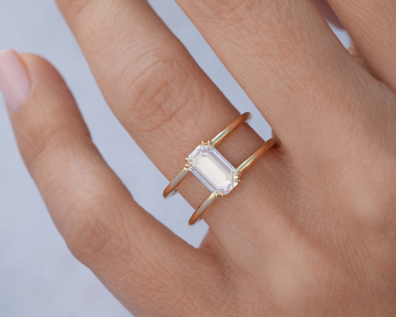 0.73-Carat Emerald Cut diamond clementine ring on ring finger