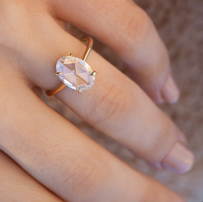 solitaire engagement ring on finger