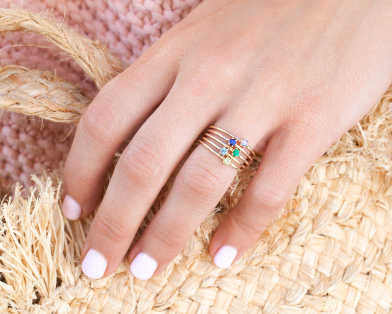 peridot stacking ring on model hand with several other stacking rings