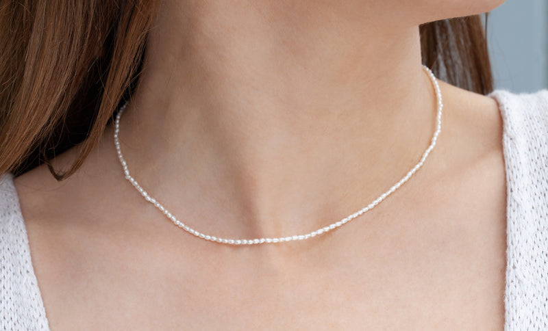cultured pearl necklace on woman side profile